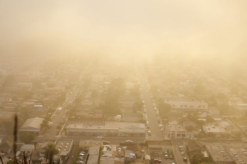 Hazy, smog-filled sky over a city skyline on a poor air quality day