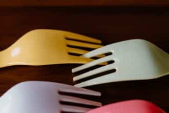 Colorful disposable plastic forks fanned out on a surface