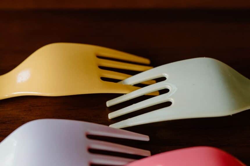 Colorful disposable plastic forks fanned out on a surface