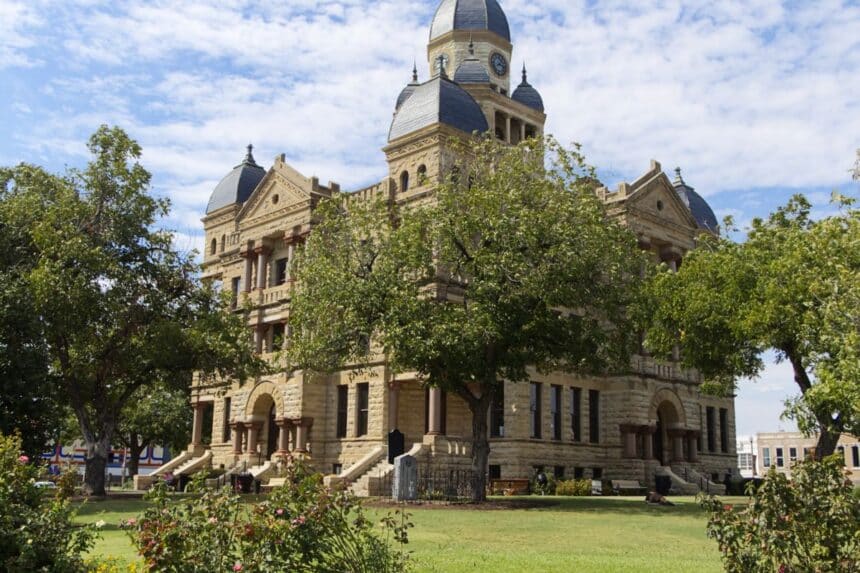 A historic county courthouse with tall columns, representing the justice system.