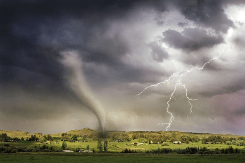 A tornado over open countryside with lightning during a severe storm