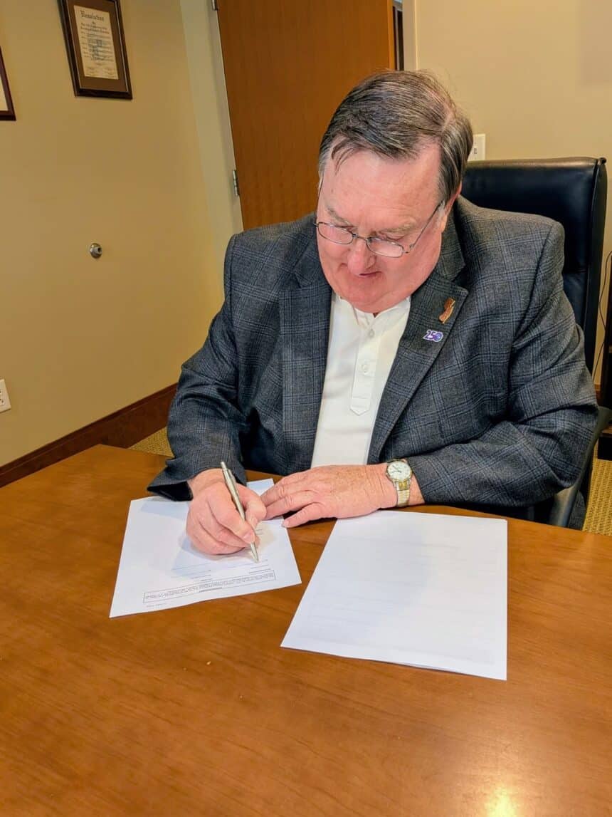 Denville Mayor Thomas Andes signs closing documents for the St. Francis property acquisition