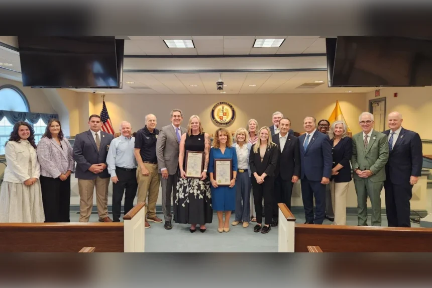 County commissioners, prosecutors and Mental Health Association clinicians stand together holding framed resolutions marking one year of the countywide ARRIVE Together program in Morris County.