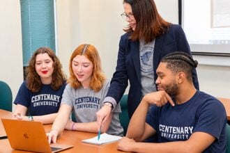 Centenary University students work on a class project with a professor