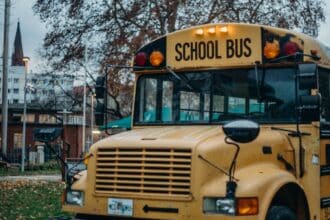 Yellow school bus on a road, illustrating the Denville NJ schools guide
