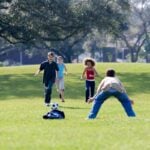 Children playing soccer on a grass field, illustrating the youth sports in Denville NJ guide