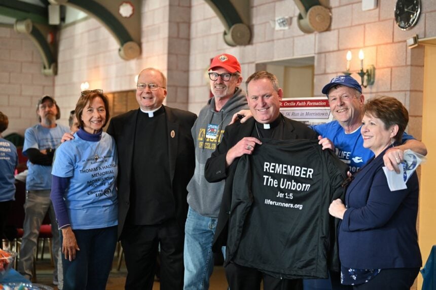 Bishop Kevin J. Sweeney with members of St. Cecilia's LIFE Runners