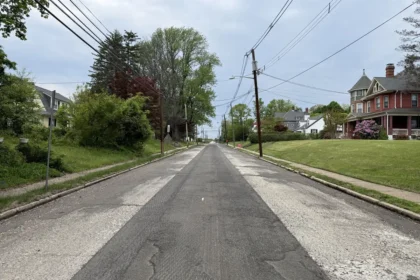 A residential New Jersey street with its top layer of asphalt milled off, ready for repaving.