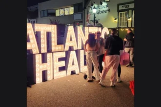 Lighted Atlantic Health marquee letters on Broadway in Downtown Denville, from the Pink Witches Night Out event listing